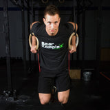 man working out with Bear Komplex wooden rings and Bear KompleX Resistance Bands