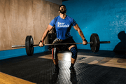 Man lifting using stars and striped knee sleeves