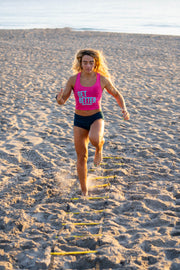 woman using BKX Agility Ladder at the beach in sand