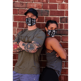 Man and woman wearing BKX Face Mask with brick background