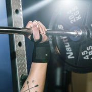 closeup of hand lifting heavy weights wearing Bear KompleX Wrist Wraps