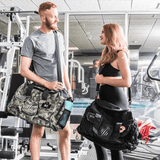 man and woman with Bear Komplex Gym bags