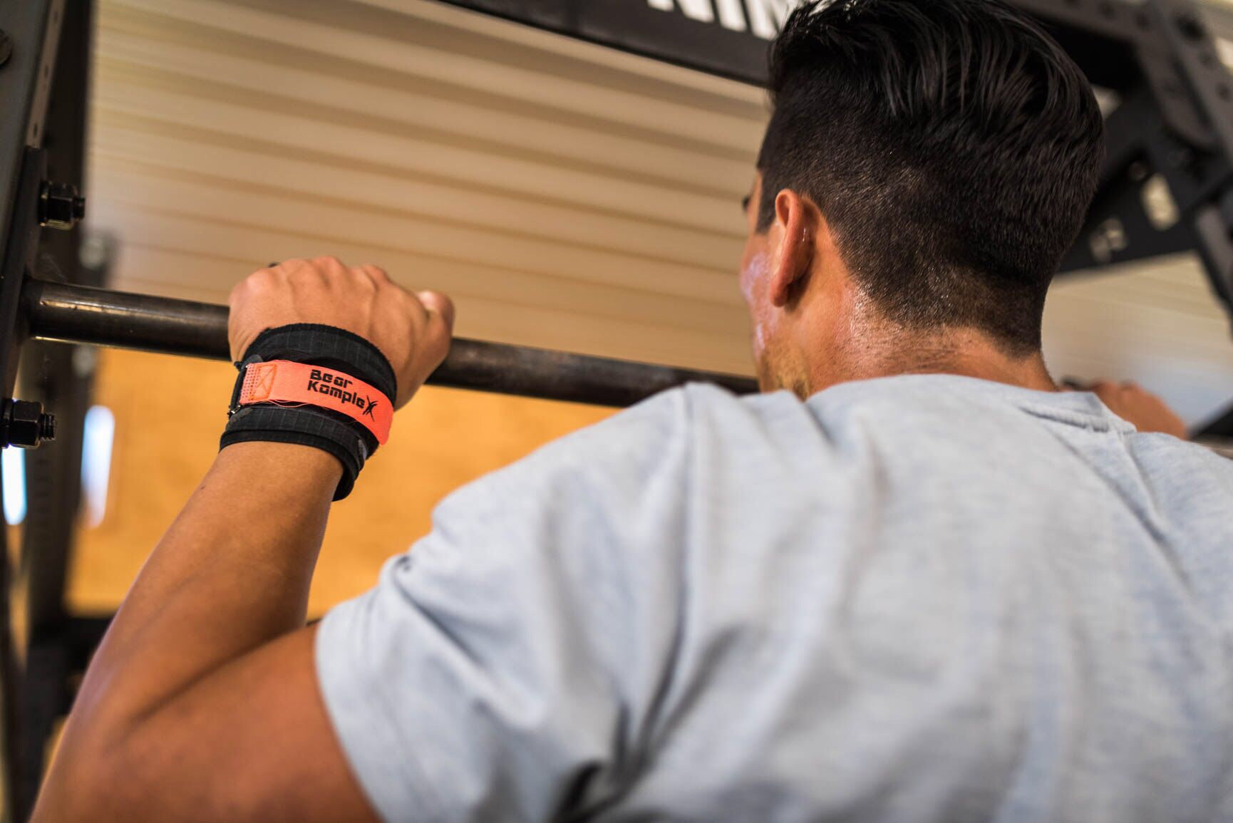 Man doing pull up using Bear KompleX Carbon Comp Grips