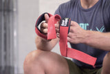 man getting ready to lift with red straps