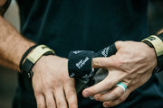 different angle showing the thumb being wrapped with sports tape