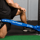 Man working out with Bear KompleX Blue Resistance Heavy Band