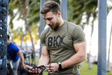 Man wearing Bear KompleX Men's T-Shirt - Military Green BKX before a workout