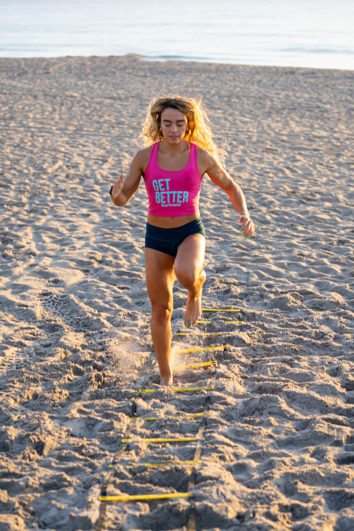woman using BKX Agility Ladder at the beach in sand