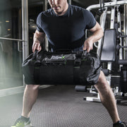 man working out with sandbag