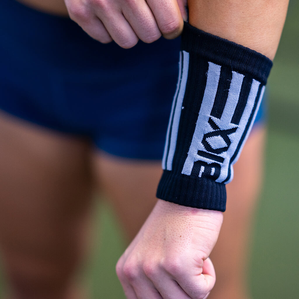 Pulling up BKX Wristbands on arms