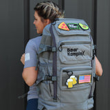 Woman showing gray Military Backpack back view