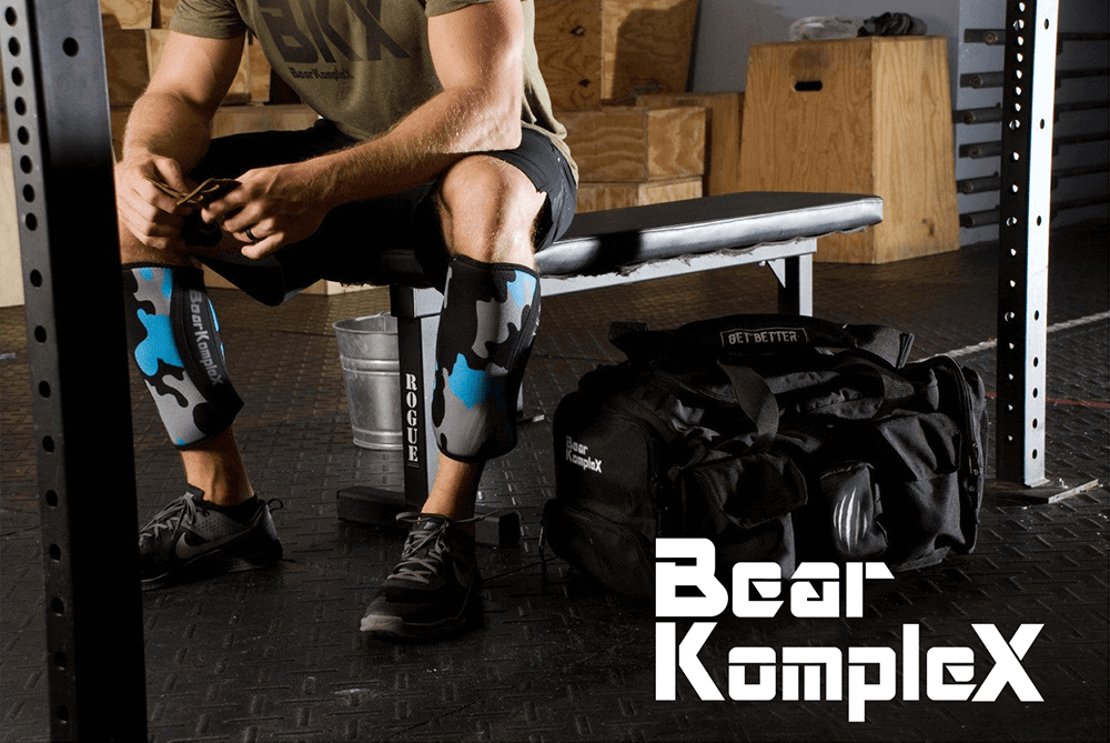 man sitting with knee sleeves and weightlifting gloves