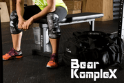 man wearing black camo knee sleeves before workout