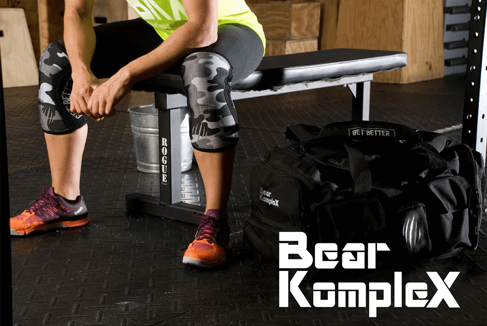 man wearing black camo knee sleeves before workout