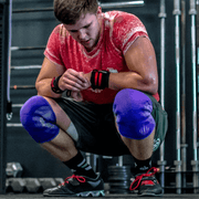 man resting with knee sleeves on