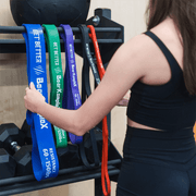 Woman choosing Bear KompleX Resistance Bands