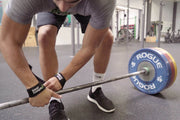 getting the barbell ready with lifting straps